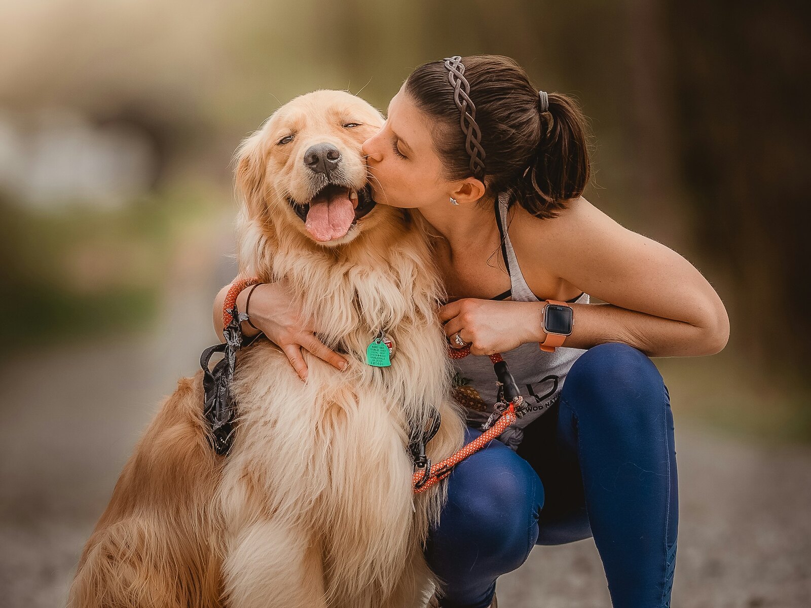 A member of the Paw House team with a happy dog
